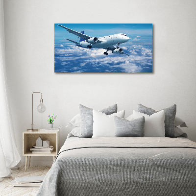 Bild auf leinwand Ein Flugzeug in den Wolken