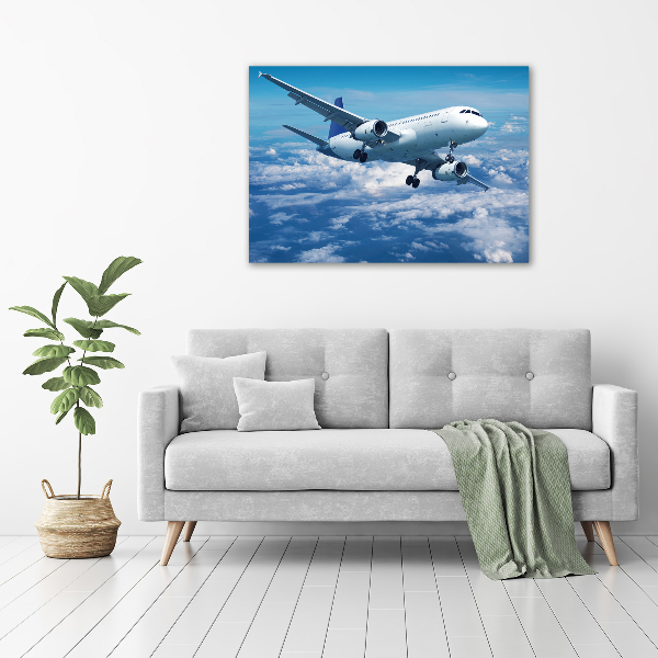 Bild auf leinwand Ein Flugzeug in den Wolken