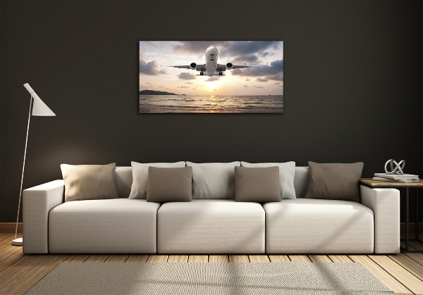 Foto glasbild Ein Flugzeug über dem Meer