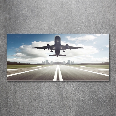 Glasbild Ein Flugzeug startet