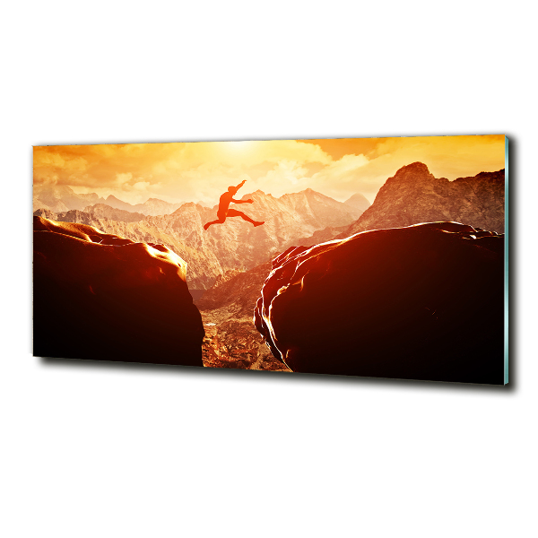 Glasbild Spring über den Abgrund