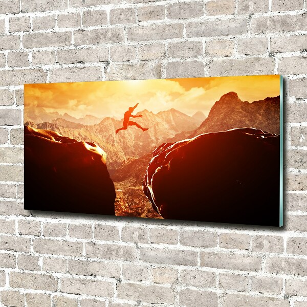 Glasbild Spring über den Abgrund