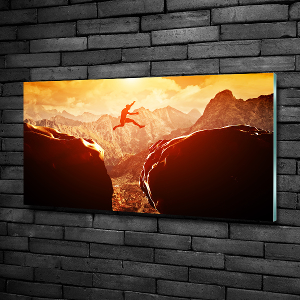 Glasbild Spring über den Abgrund