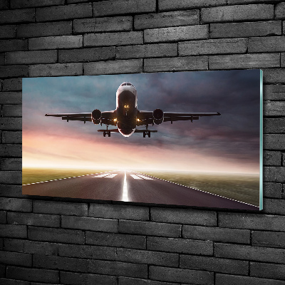 Glasbild Ein Flugzeug startet