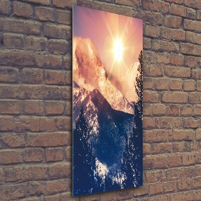 Glasbild vertikales Die Sonne über den Bergen