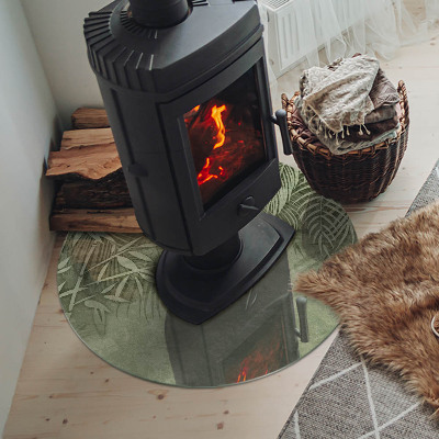 Runde Glasplatte für Kaminofen Tropische Blätter im Hintergrund