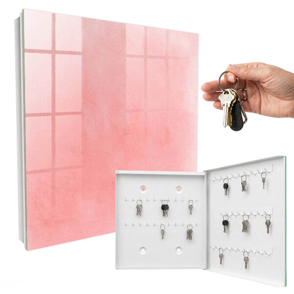 Schlüsselbox für die Wand mit rosa Hintergrund
