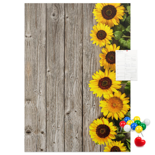 Kork-Pinnwand mit Sonnenblumen auf Holzbrett-Hintergrund