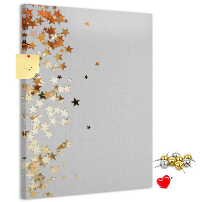 Pinnwand mit goldenen und silbernen Sternen auf grauem Grund