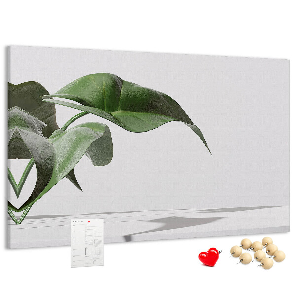 Kork-Pinnwand zarte Blätter auf minimalistischem Hintergrund