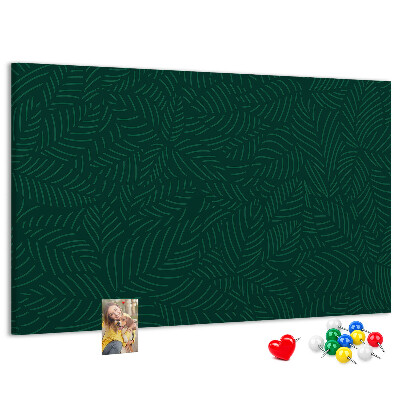 Korktafel mit Motiv grüne Blätter auf dunklem Hintergrund