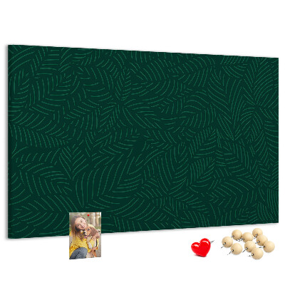 Korktafel mit Motiv grüne Blätter auf dunklem Hintergrund