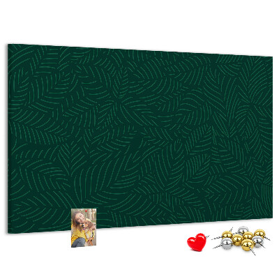 Korktafel mit Motiv grüne Blätter auf dunklem Hintergrund