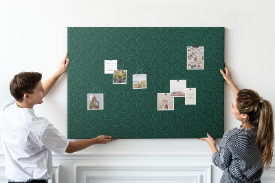 Korktafel mit Motiv grüne Blätter auf dunklem Hintergrund